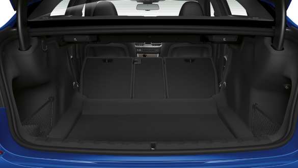 BMW 3-serie Sedan med gjennomlastingssystem. Nærbilde av åpent bagasjerom med bakseteryggene delvis lagt ned.