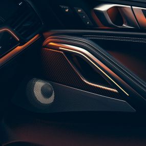 BMW X6 høyttalere. Nærbilde av BMW-interiøret med fokus på høyttalerboks.