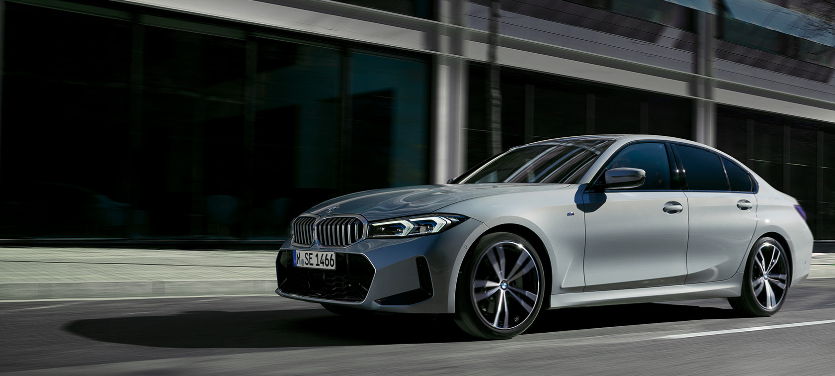 BMW 3-serie Sedan LCI G20 Brooklyn Grey sett fra siden stående foran vegg