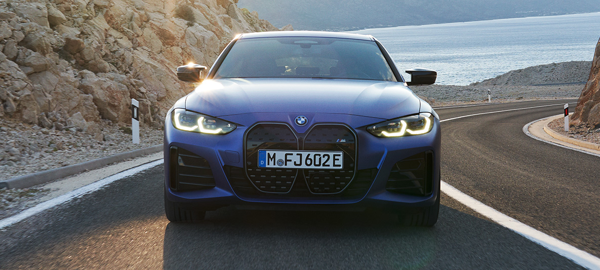 Sett forfra BMW i4 M50 G26 2021 kjørende BMW i4 M50 G26 2021 M Portimaoblå metallic Sett forfra kjørende på veien