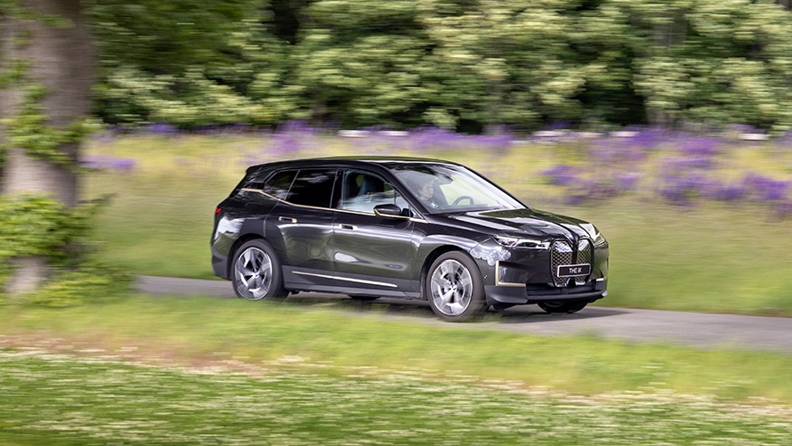 BMW iX körandes på landsväg. BMW iX körandes på landsväg.